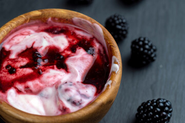 fresh yogurt with crushed juicy blackberries, preparation of yogurt