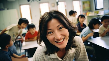 An Asian female teacher has fun with her little students in the classroom