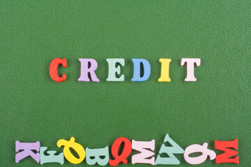 CREDIT word on green background composed from colorful abc alphabet block wooden letters, copy...