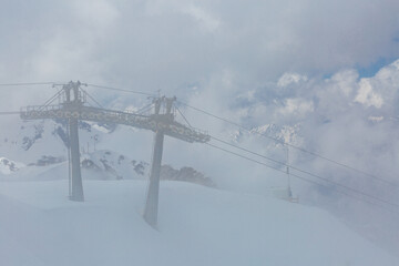 Ski infrastructure and mountains in cloudy weather - 687262834