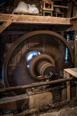 Old functional wooden water mill wheel. Grinding grain into flour in the traditional way using water power and a millstone. A historical example of a retro industrial factory. Oblazy Slovakia.