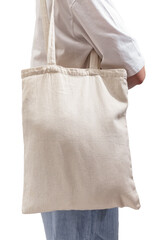 Girl carrying textile shopper, eco linen tote bag on shoulder, isolated on white