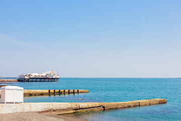 Piers in the Black Sea on a pebble beach in sunny weather - 687265025
