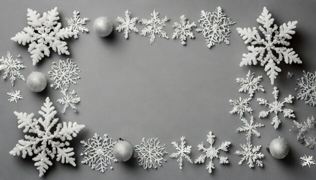 a christmas picture made up of snowflakes on a pale gray background represents the winter season photographed from above with the frame laid out and room for text