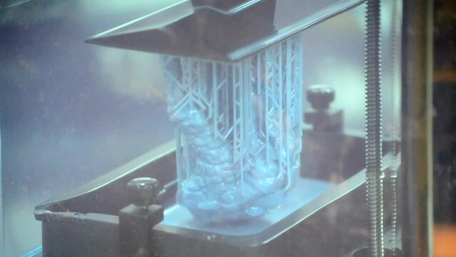 3D printer working process. 3D printing. Stereolithography photopolymerization SLA. Additive manufacturing technology. Liquid materials, hard part, creating layers. 3D model ultraviolet polymerization