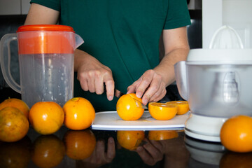 a man preparing a healthy breakfast with orange juice
