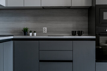 The kitchen is in shades of gray. kitchen appliances. table