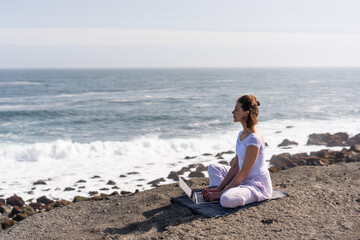 Girl freelancer doing work on the ocean