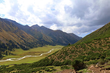 Fototapeta na wymiar Ak-Suu valley with a glacier river on Fifth stage of Ak-Suu Traverse trek in Tian Shan mountains, Karakol, Kyrgyzstan