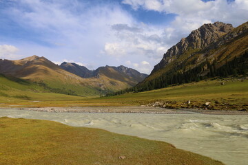 Ak-Suu river wading on fifth stage of Ak-Suu Traverse trek in Tian Shan mountains, Karakol, Kyrgyzstan