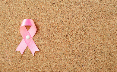 Pink ribbon on a corkboard