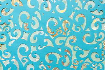 blue die-cut scrapbooking paper sheet with arabesque or floral pattern on crafting paper with...