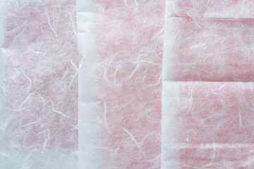 folded or crease tissue paper with fiber texture over red paper