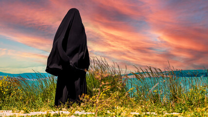 As daylight fades on the lakeside, a veiled figure stands on a lofty hill, quietly observing the...