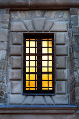 Old window on the facade of a historic monastery.