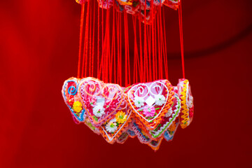 Red heart shaped lolly pops, sweetheart necklace on Christmas markets are traditional souvenir edible gifts - 687289668
