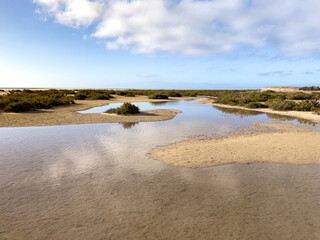 As the tide comes in, the lagoon fills at Sotavento Beach, Fuerteventura