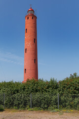 Fototapeta na wymiar Akmenraga lighthouse in Latvia. Tall red tower.
