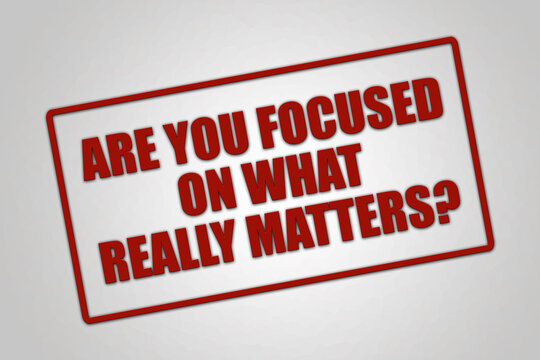 Are you focused on what really matters? A red stamp illustration isolated on light grey background.