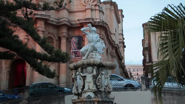 noto sicily italy statue monument of person drinking with zoom in
