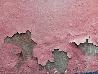 Weathered cement wall with flaking and peeling paint. Abstract grunge wall texture background. Aged concrete wall with copy space.