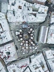 Aerial view of the Christmas market in Tallinn's old town townhall square, Raekoja Plats, in winter.
