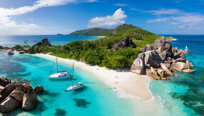 aerial pano of grand anse beach at la digue island in seychelles white sandy beach with blue ocean lagoon and catamaran yacht moored - obrazy, fototapety, plakaty