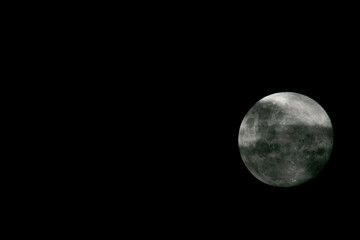 Moon and clouds in the black night