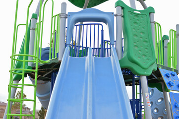Empty Playground Slide and Climbing Wall