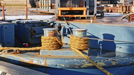 Transport Barge Moored with Thick Jute Rope Tangled Around Deck Bollard