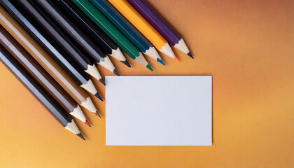 mockup of colored pencils, idea for graphic designers and art schools, top view with copy space; blank business card with group of multicolored crayons. paper template for artist or student