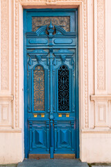 travel to Georgia - ornamental carved wooden door at entrance to residential apartment building in Batumi city on autumn day