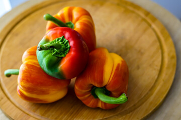 Colorful peppers on the wooden board