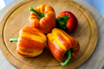 Colorful peppers on the wooden board