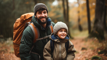 smiling son and father walking with backpacks through the forest, nature reserve, hiking, tall trees, blurred background, man, boy, trail, tourists, travel, hike, family, weekend together, child, kid