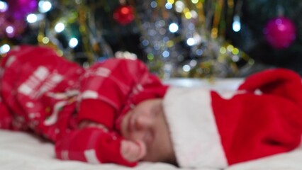 Sleeping, two week old, newborn, baby boy wearing a crocheted Santa hat with snowman plush toy....