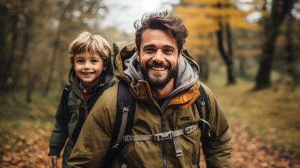 Fototapeta premium smiling son and father walking with backpacks through the forest, nature reserve, hiking, tall trees, blurred background, man, boy, trail, tourists, travel, hike, family, weekend together, child, kid