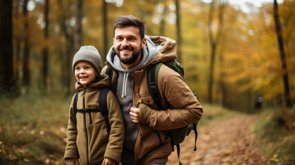 Fototapeta premium smiling son and father walking with backpacks through the forest, nature reserve, hiking, tall trees, blurred background, man, boy, trail, tourists, travel, hike, family, weekend together, child, kid
