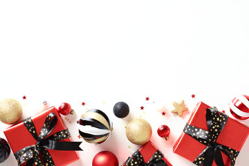 Top view Christmas background with red gift boxes, vintage baubles, decorations on white table....