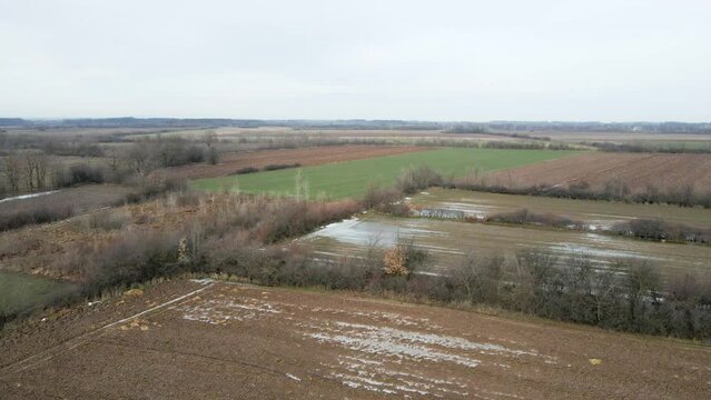 Drone flight above flooded agricultural fields in Ub, Serbia in cloudy day