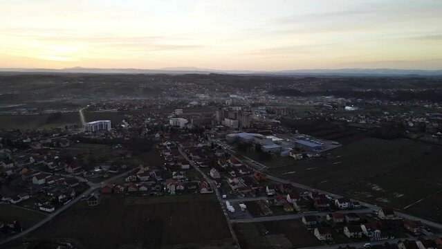 Drone footage of the countryside lake near a village during sunset