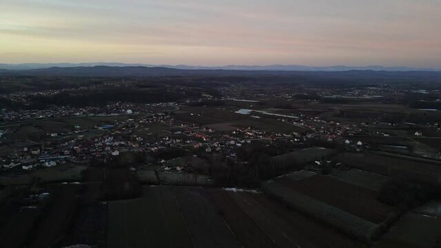 Aerial footage of the countryside lake near a village during sunset