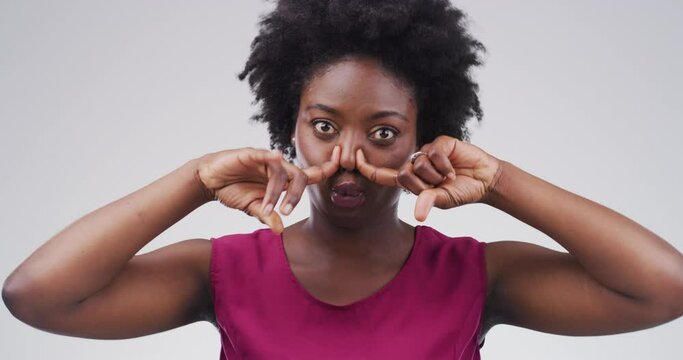 Goofy expression, portrait of black woman in studio with funny and positive attitude for meme, post or comedy. Crazy emoji, silly show and face of happy girl with comic facial on white background.