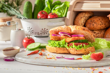Spicy and delicious sandwich with chicken, tomato and lettuce - obrazy, fototapety, plakaty