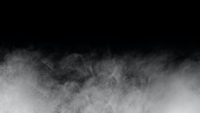 White smoke or fog isolated on black background. Soft Fog  on Dark Backdrop. Realistic Atmospheric Gray Smoke on Black Background.