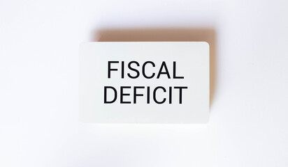 FISCAL DEFICIT text on sticker on notebook with magnifier and chart. Business.