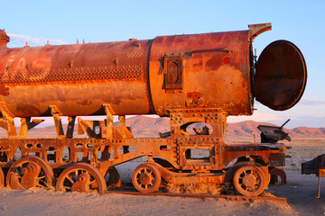Side profile of rusted vintage train locomotive at the train cemetery in Uyuni, Bolivia, a popular travel destination. © Fearless on 4 Wheels