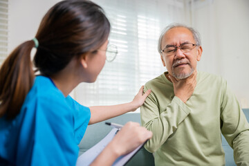 Asian young nurse checking senior man neck pain in clinic at retirement home, doctor woman examines...