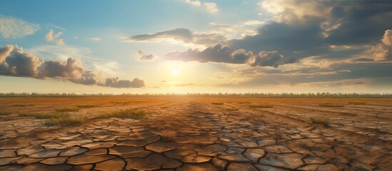 Dry cracked parched earth with sky blue and horizon. Global warming concept and climate change - obrazy, fototapety, plakaty