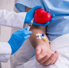 Male patient getting blood transfusion in hospital clinic